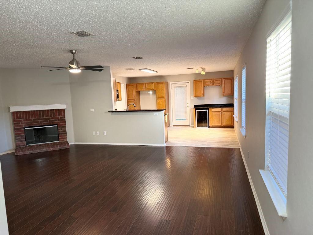 8201 Canoe Ridge Lane Denton, TX 76210 - Photo 4 of 25 wooden floor in an empty room with a window