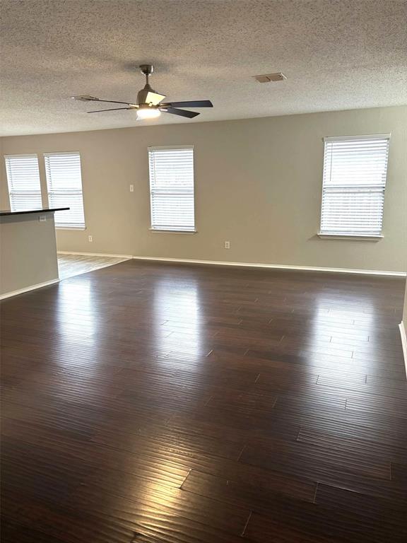 8201 Canoe Ridge Lane Denton, TX 76210 - Photo 5 of 25 a view of an empty room with wooden floor and a window