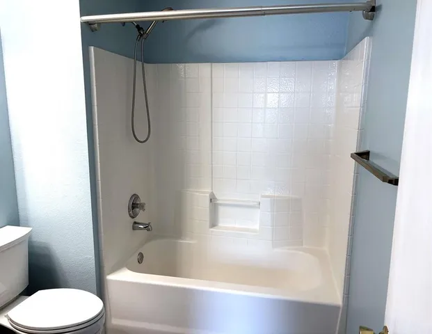 a bathroom with a bathtub and a toilet