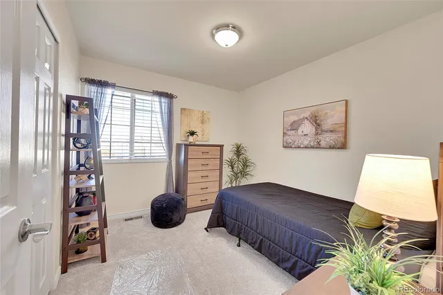 a bedroom with furniture and a window