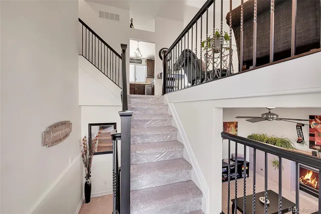 a view of staircase with lots of frames on wall and windows
