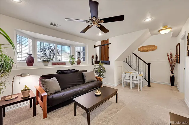 a living room with furniture and a large window