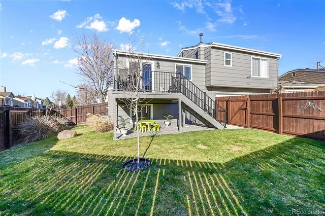 a view of an house with backyard porch and outdoor kitchen