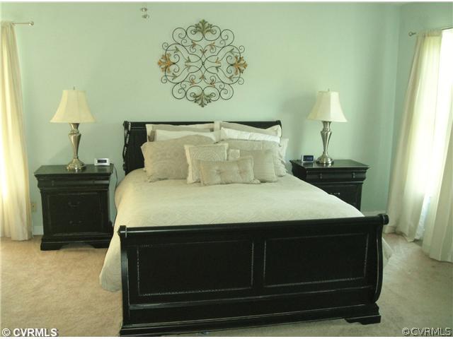15015 Walnut Bend Road Midlothian, VA 23112 - Photo 7 of 12 a bedroom with a bed and a table in it