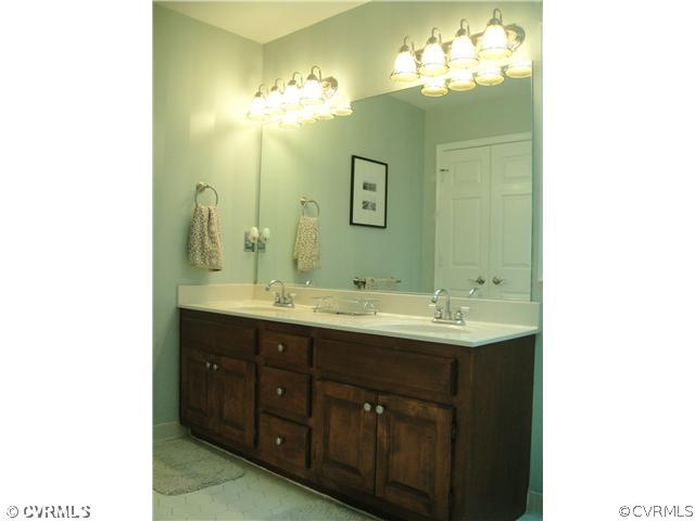15015 Walnut Bend Road Midlothian, VA 23112 - Photo 8 of 12 a bathroom with a double vanity sink and a mirror