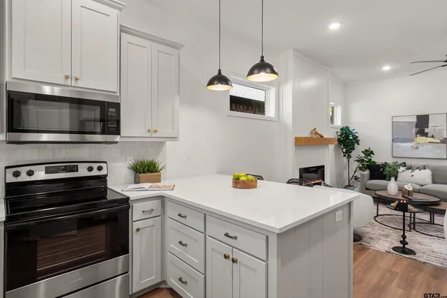 a kitchen with a sink a stove and microwave