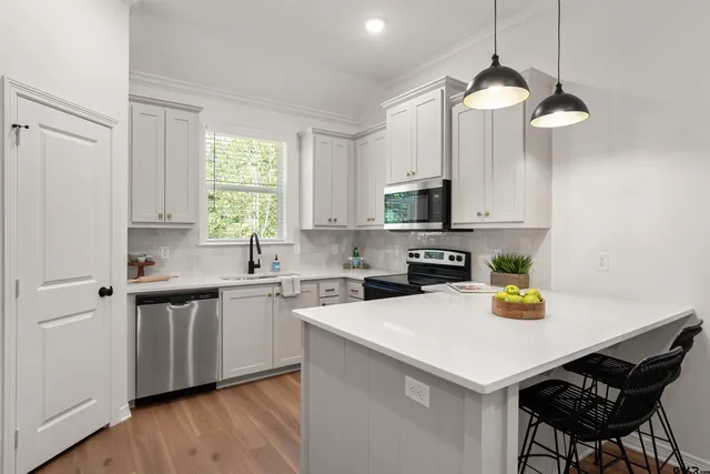 a kitchen with a sink a window and appliances