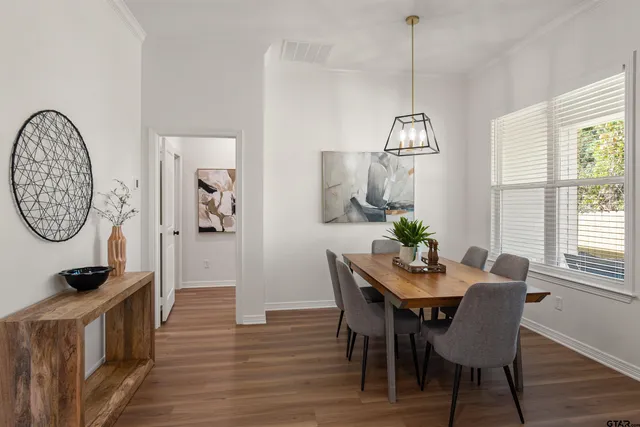 a view of a dining room with furniture window and wooden floor
