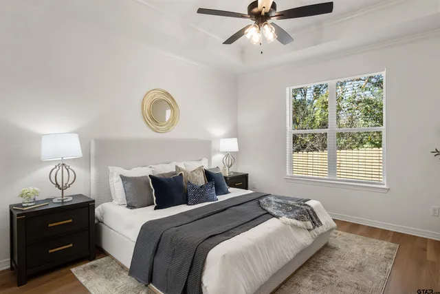 a bedroom with a bed and window with lamp