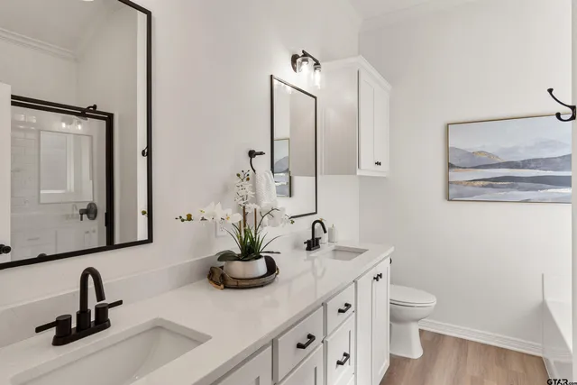 a bathroom with a double vanity sink and a mirror