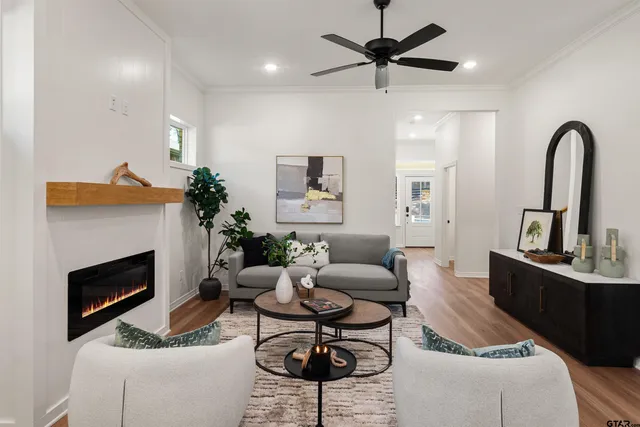a living room with furniture a fireplace and a potted plant