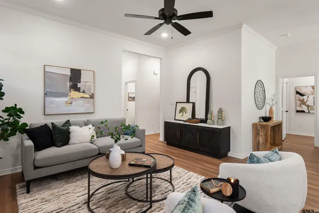 a living room with furniture and a mirror