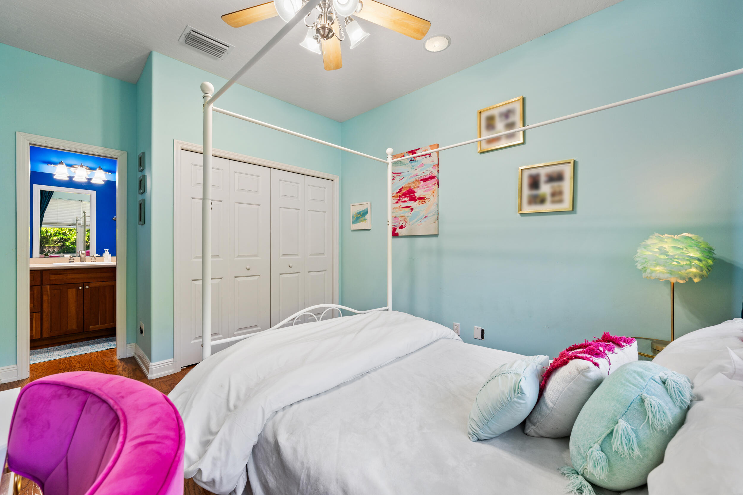 619 Fischer Hammock Road Sebastian, FL 32958 - Photo 16 of 36 a bedroom with a bed and a chandelier