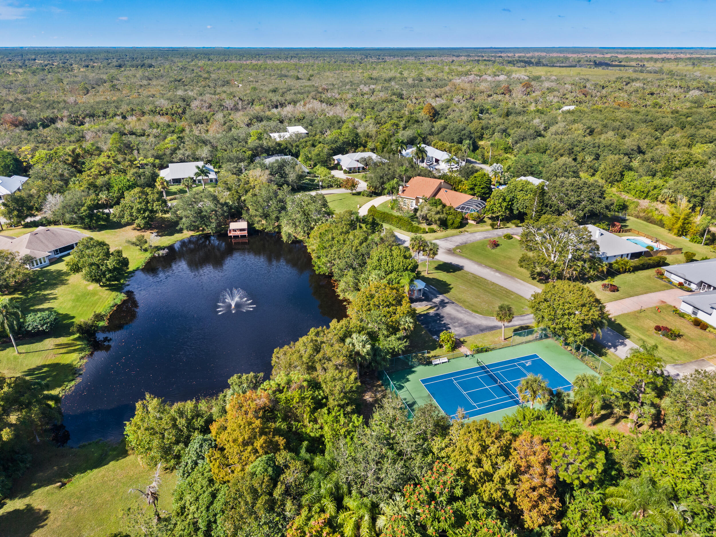 619 Fischer Hammock Road Sebastian, FL 32958 - Photo 34 of 36 an aerial view of residential houses with outdoor space and trees