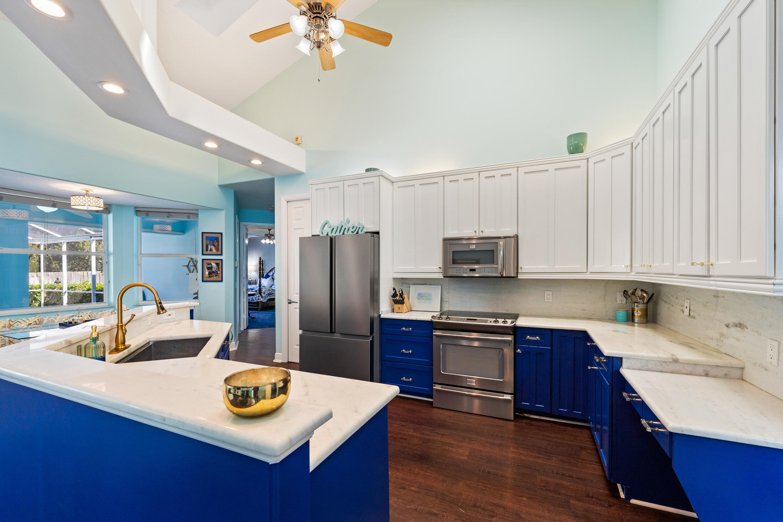 619 Fischer Hammock Road Sebastian, FL 32958 - Photo 4 of 36 a kitchen with a refrigerator a stove a sink dishwasher and a dining table with wooden floor