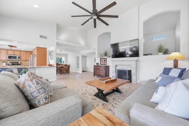 a living room with furniture a fireplace and a flat screen tv