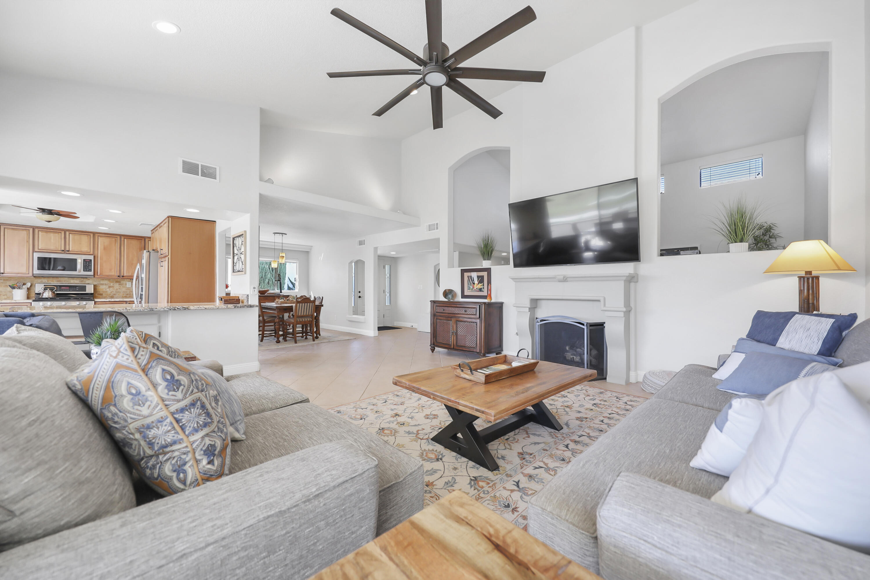 a living room with furniture a fireplace and a flat screen tv