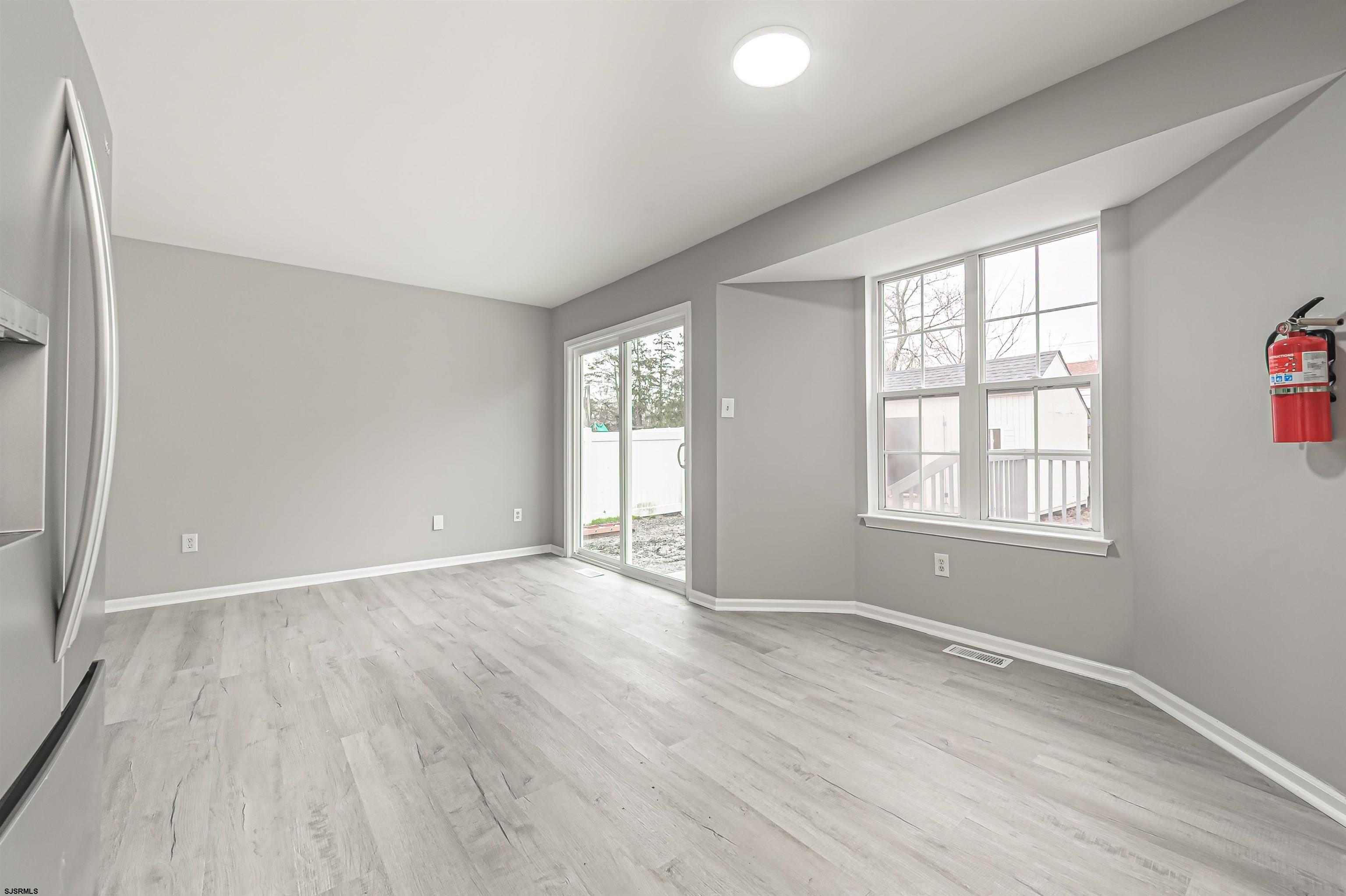 517 Superior Road Egg Harbor Township, NJ 08234 - Photo 23 of 35 an empty room with wooden floor and windows