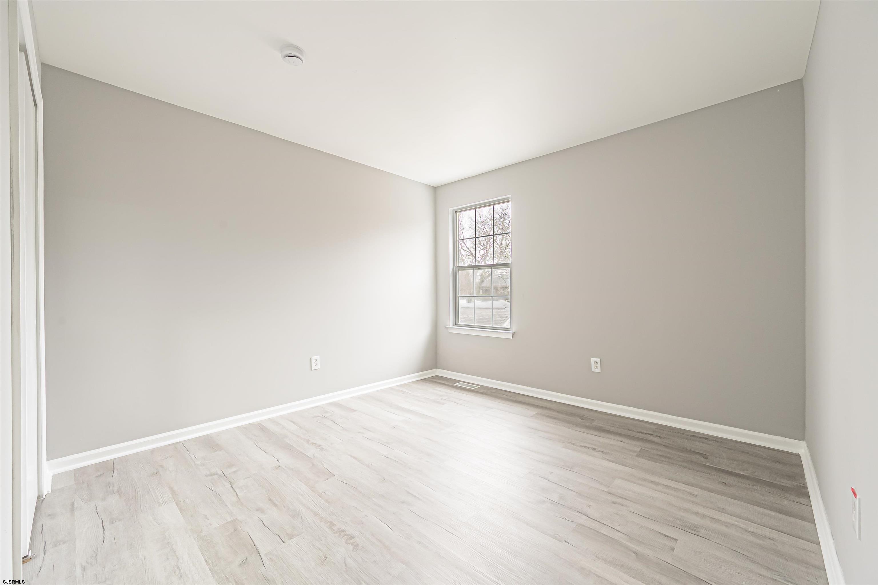 517 Superior Road Egg Harbor Township, NJ 08234 - Photo 30 of 35 an empty room with wooden floor and windows