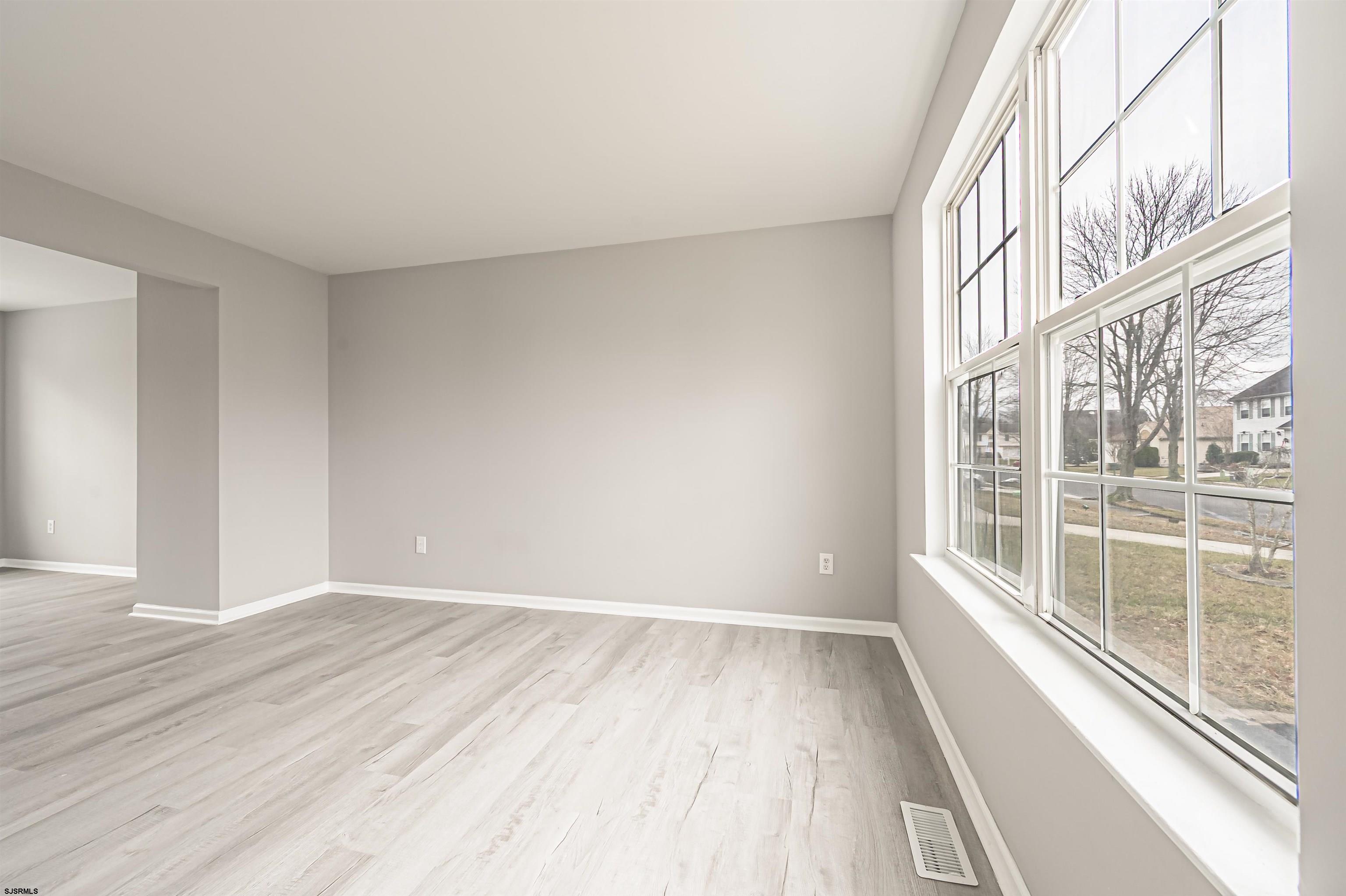 517 Superior Road Egg Harbor Township, NJ 08234 - Photo 6 of 35 wooden floor in an empty room with a window