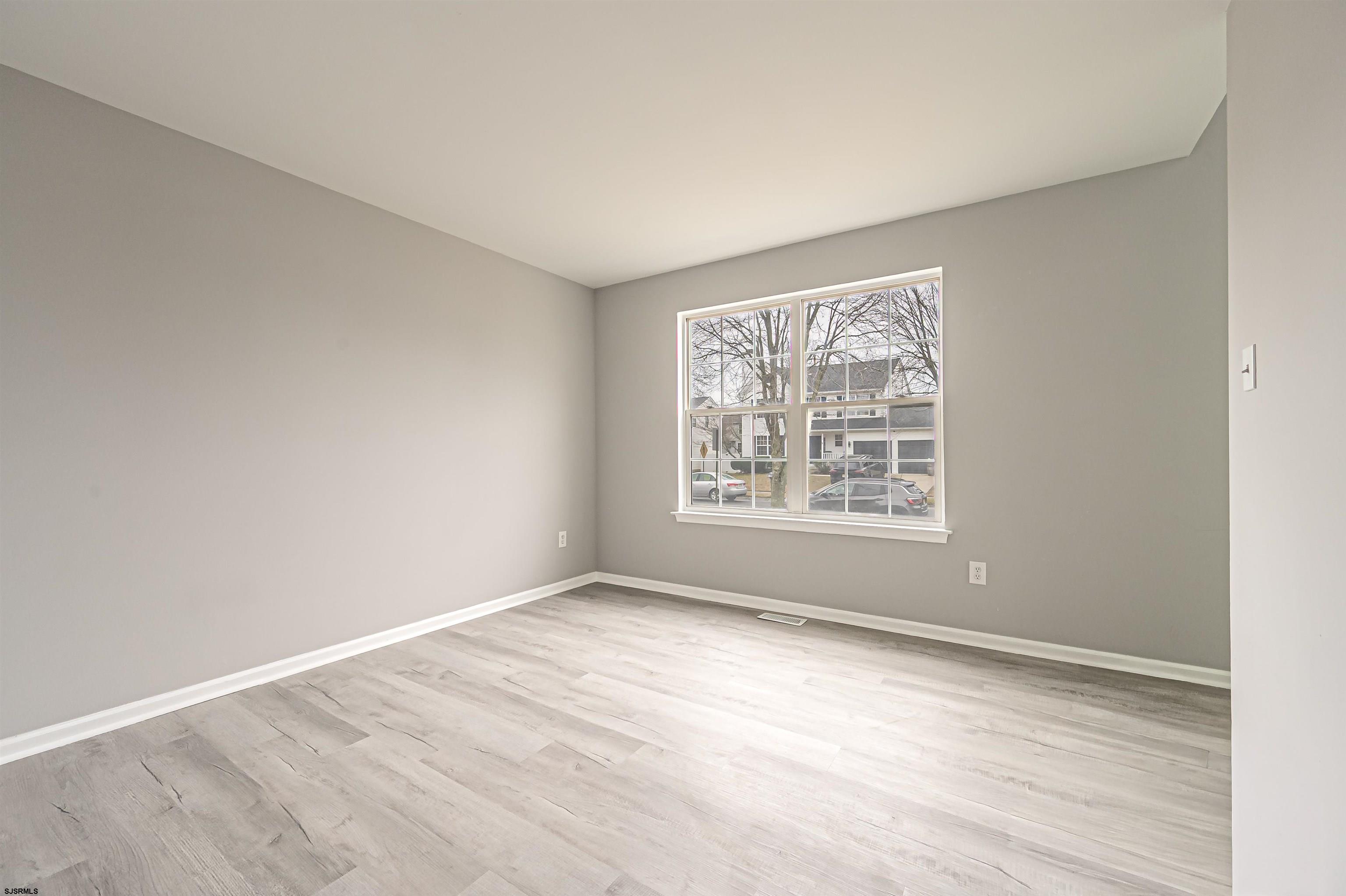 517 Superior Road Egg Harbor Township, NJ 08234 - Photo 7 of 35 a view of an empty room with wooden floor and a window