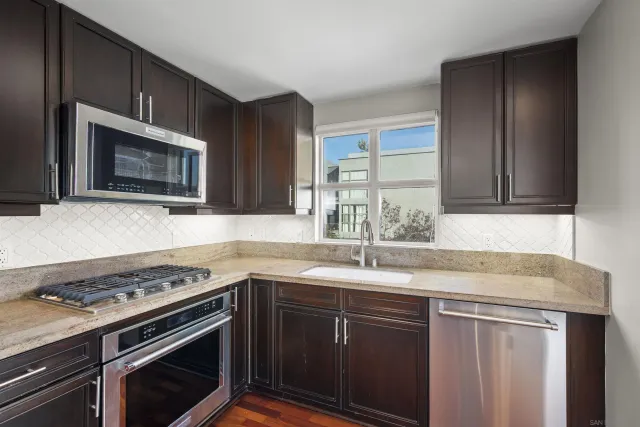 a kitchen with a sink stove and refrigerator