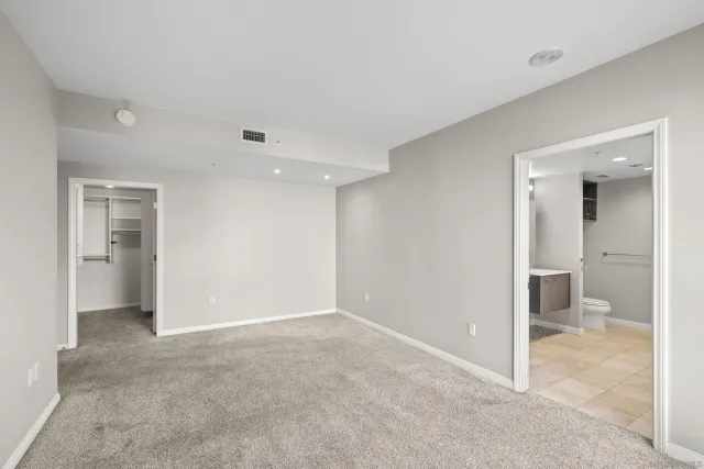 a bathroom with a sink double vanity granite tub shower and a mirror