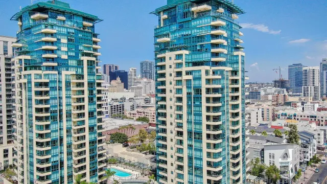 a dining room with wooden floor and large window