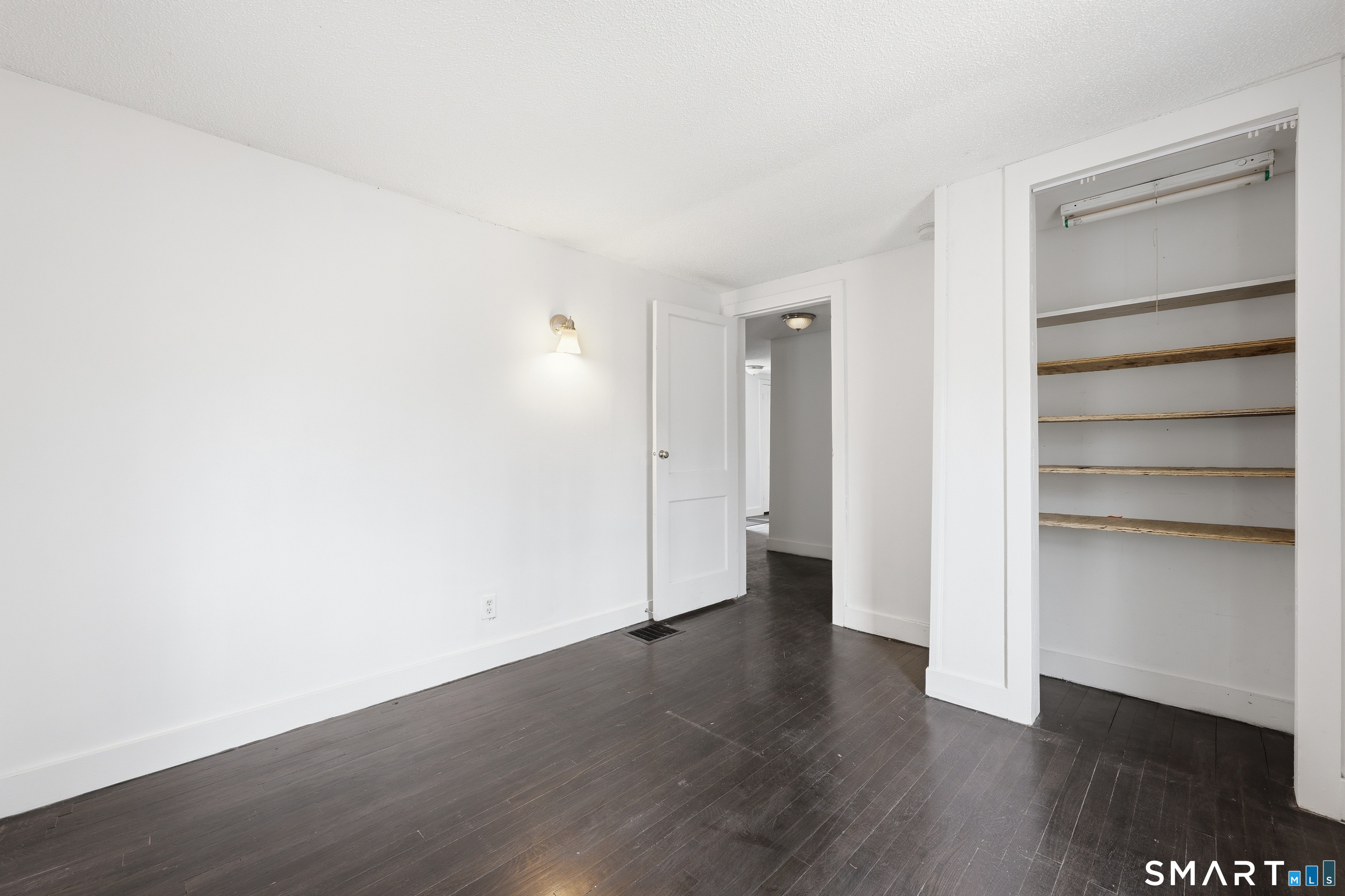 660 Opening Hill Road Madison, CT 06443 - Photo 12 of 36 a view of an empty room with a closet and wooden floor