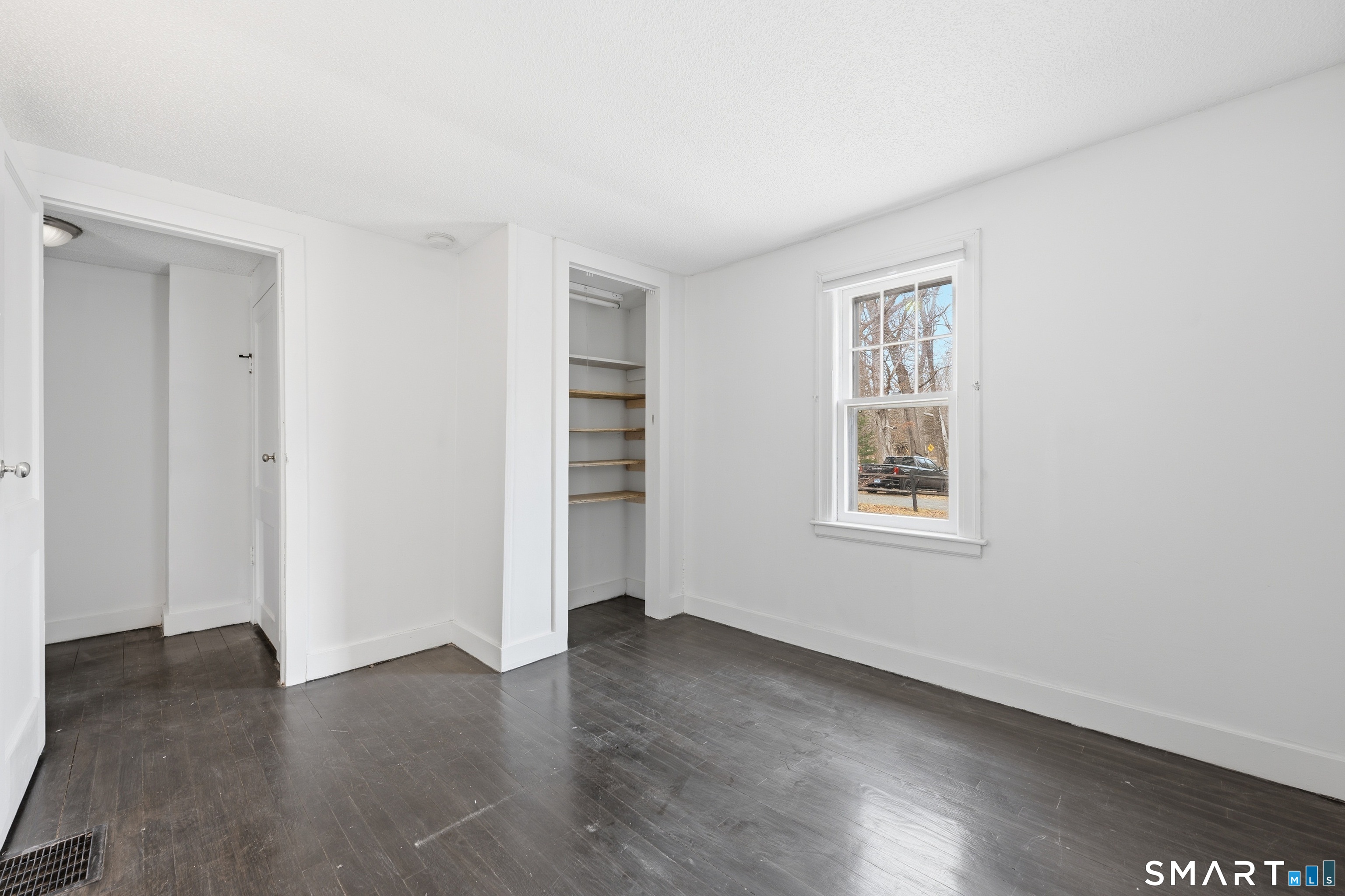 660 Opening Hill Road Madison, CT 06443 - Photo 13 of 36 an empty room with wooden floor and windows