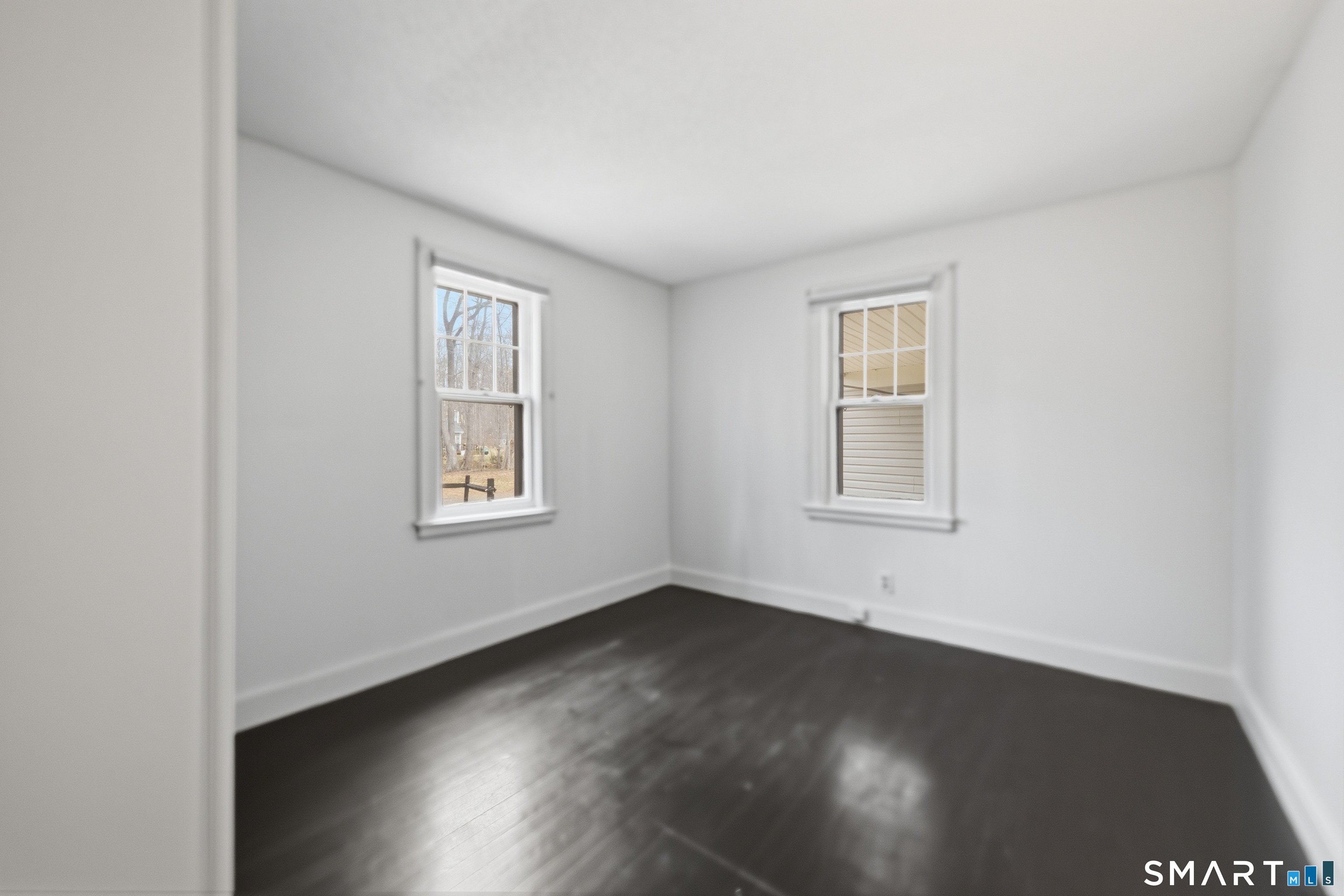 660 Opening Hill Road Madison, CT 06443 - Photo 14 of 36 an empty room with wooden floor and windows