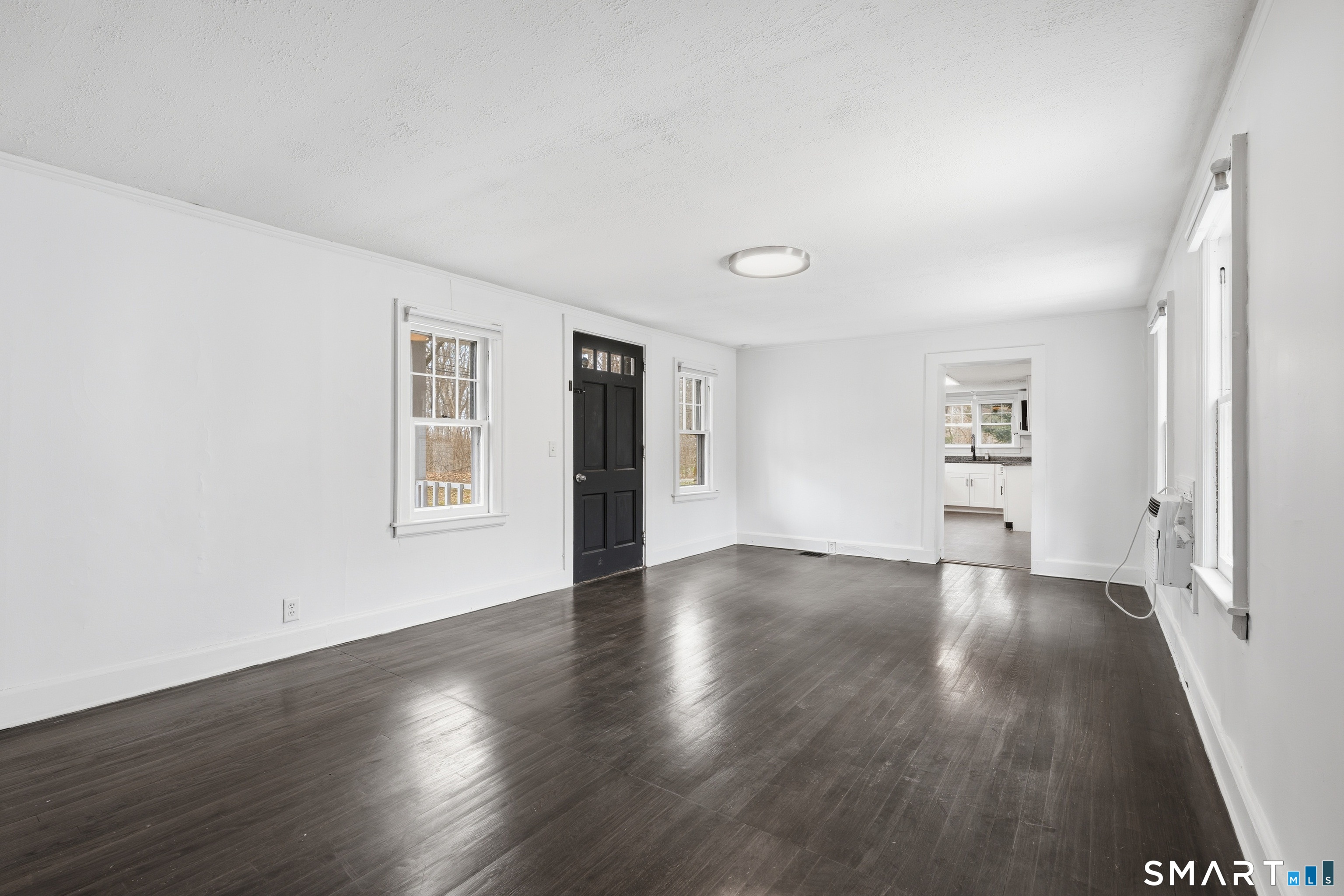 660 Opening Hill Road Madison, CT 06443 - Photo 17 of 36 an empty room with wooden floor and windows