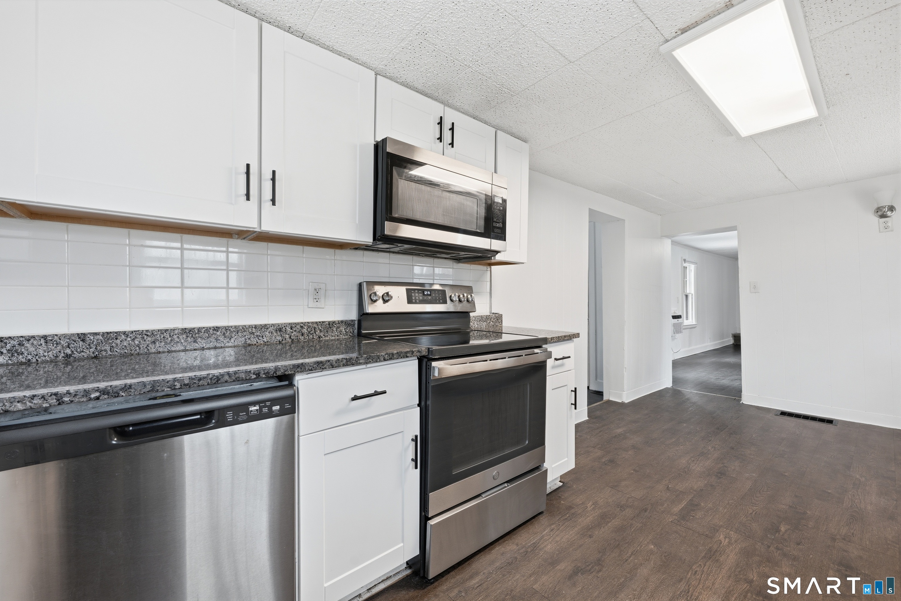 660 Opening Hill Road Madison, CT 06443 - Photo 21 of 36 a kitchen with stainless steel appliances granite countertop a stove a sink and a microwave