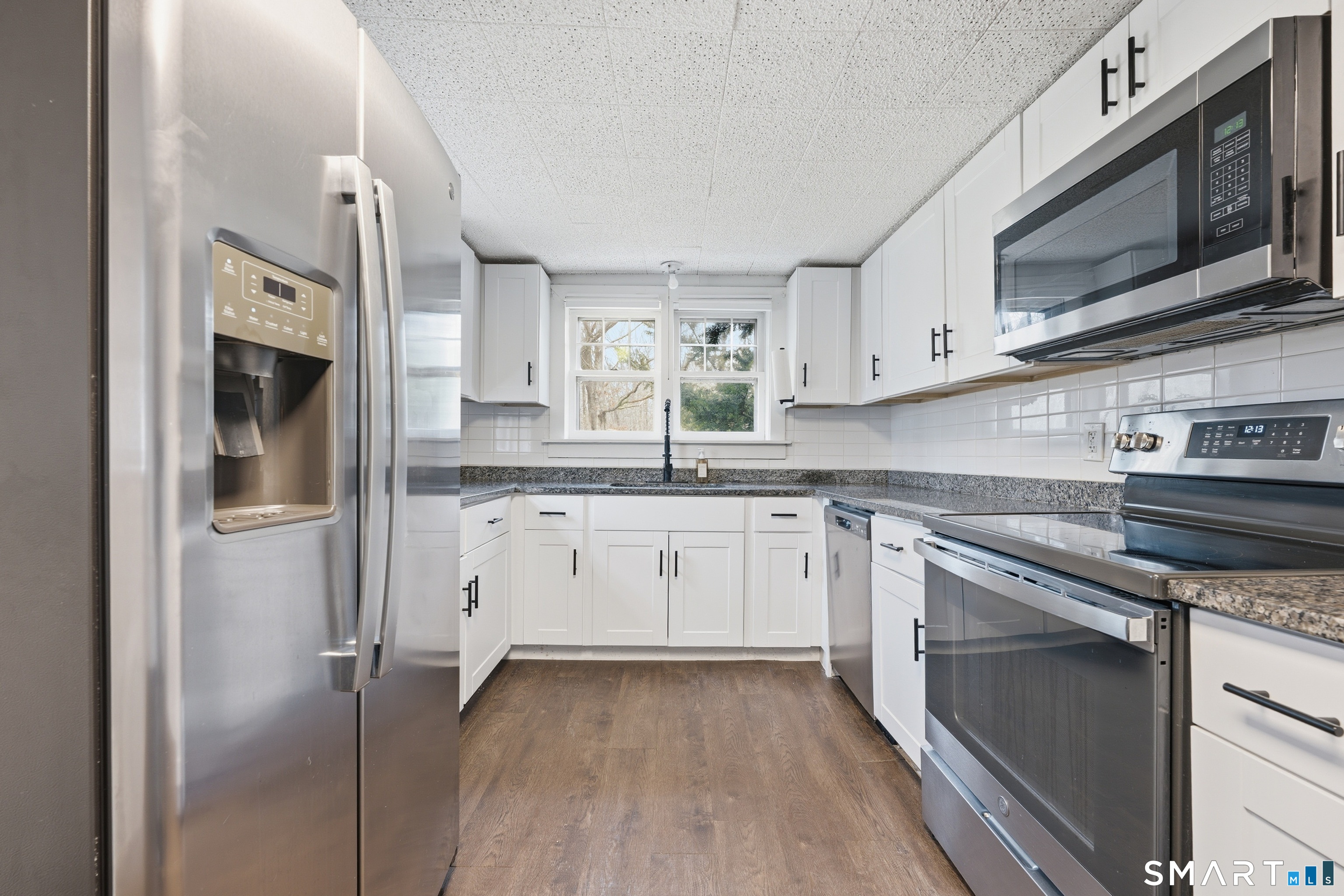 660 Opening Hill Road Madison, CT 06443 - Photo 22 of 36 a kitchen with stainless steel appliances granite countertop a stove a sink and a microwave