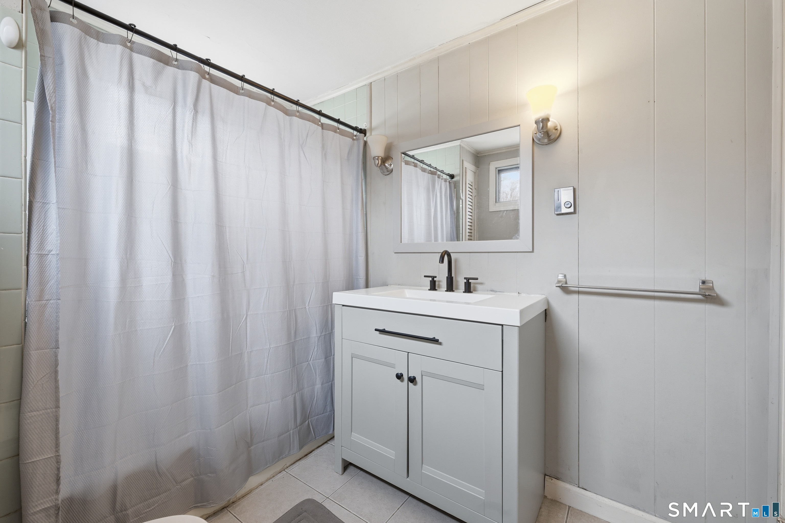 660 Opening Hill Road Madison, CT 06443 - Photo 30 of 36 a bathroom with a sink and mirror