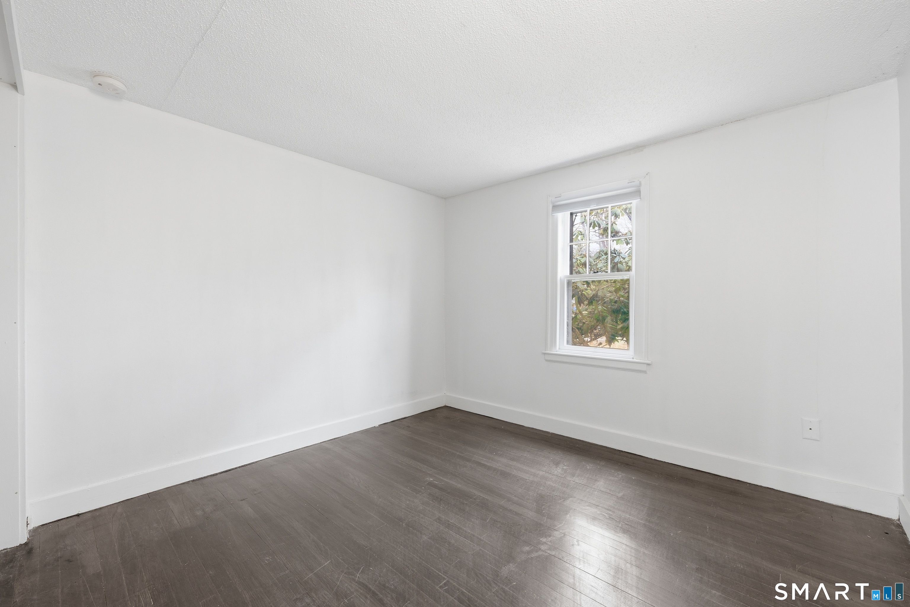 660 Opening Hill Road Madison, CT 06443 - Photo 9 of 36 an empty room with wooden floor and windows