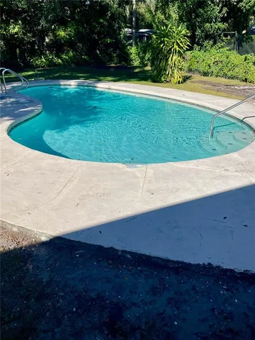 a view of a big yard with wooden fence