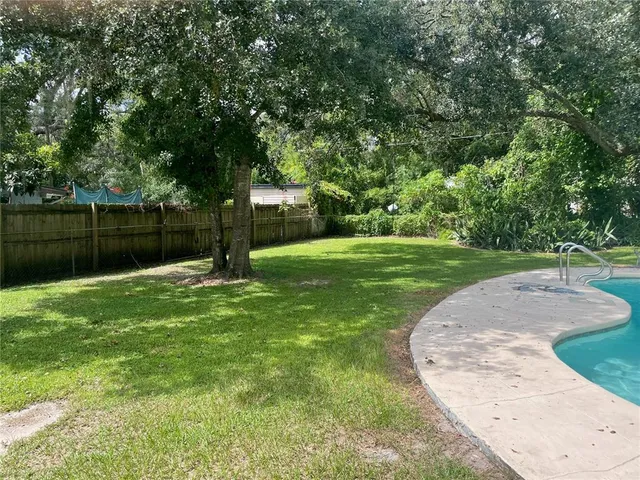 a view of a park with large trees