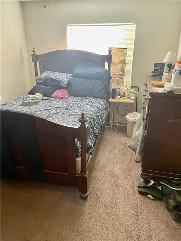 a bedroom with a bed furniture and a window