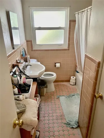 a bathroom with a sink toilet and mirror