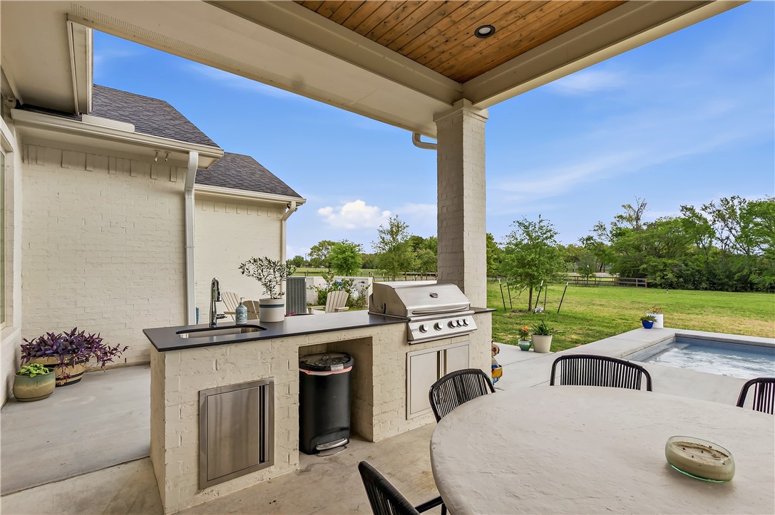 10701 Harvey Ranch Road College Station, TX 77845 - Photo 43 of 48 a view of roof deck with couches kitchen stove and kitchen island