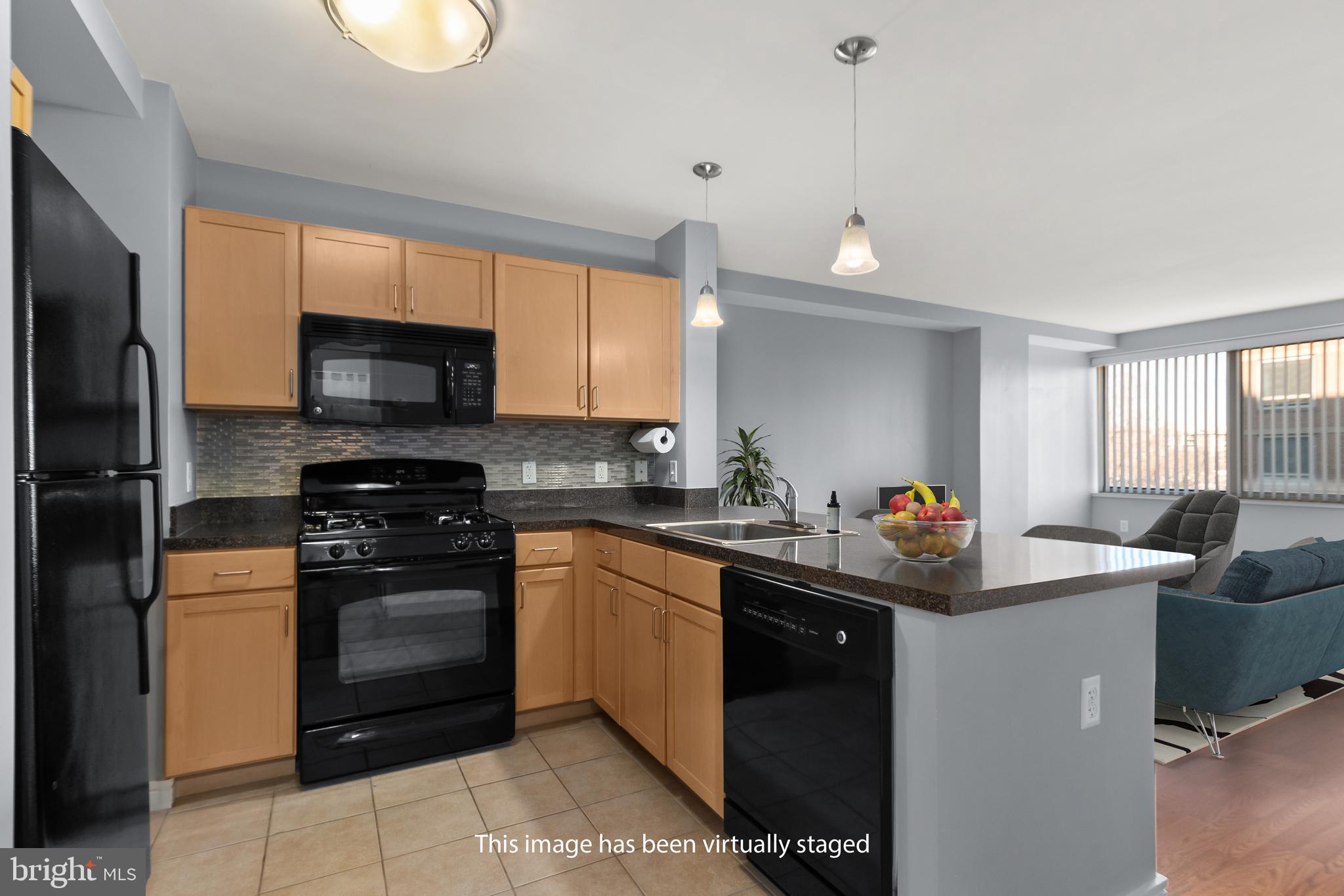 800 4th Street Southwest, Unit S312 Washington, DC 20024 - Photo 8 of 42 Kitchen with Breakfast Bar & pendant lighting.