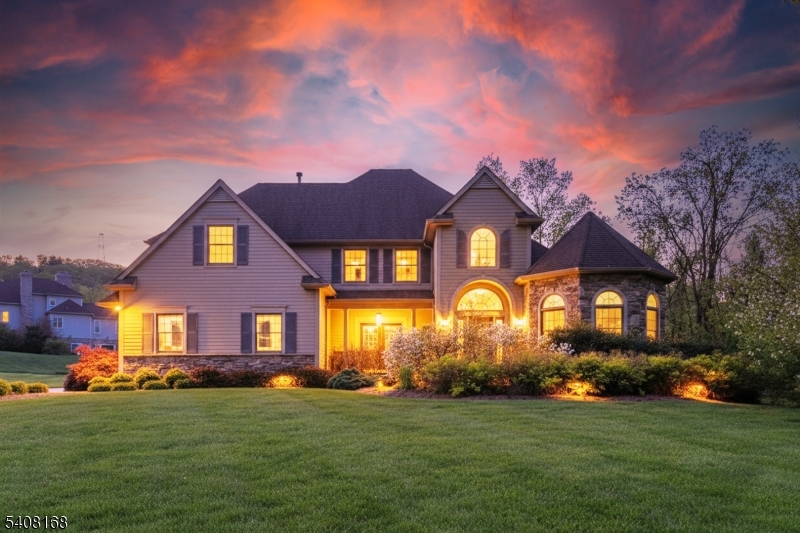 a front view of a house with a garden and yard