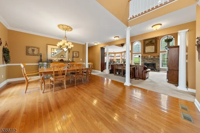 a view of a dining room with furniture wooden floor and chandelier