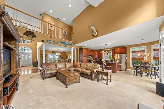 a living room with lots of furniture and a large window