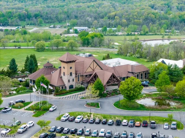 an aerial view of a house with outdoor space swimming pool and lake view