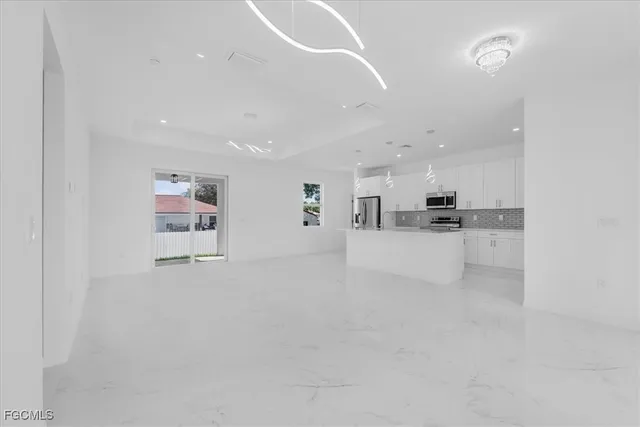 a view of kitchen and kitchen with refrigerator stove