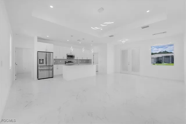 a white refrigerator freezer and a stove sitting inside of a kitchen