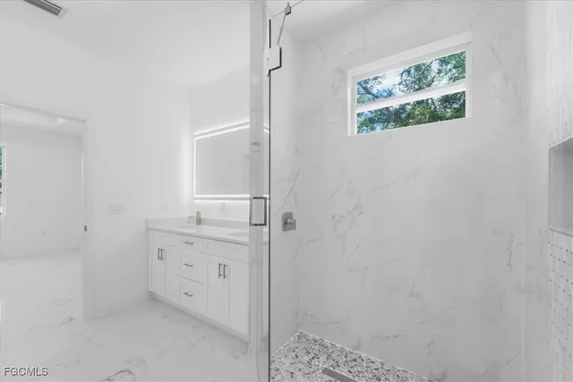 an empty room with fan and windows