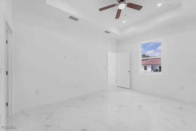 a view of a room with a ceiling fan